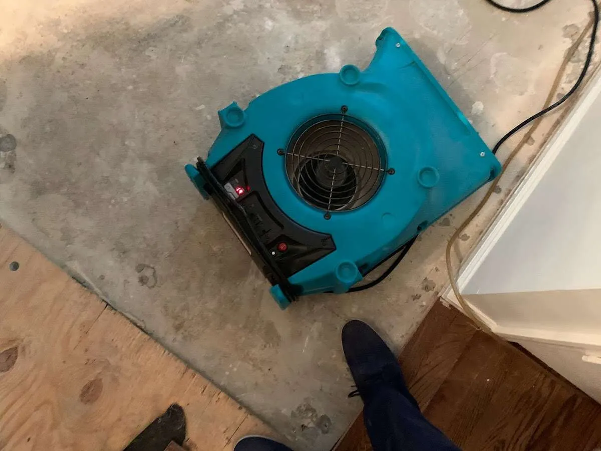Air mover drying subfloor during Commercial Water Damage Restoration in Chena Ridge